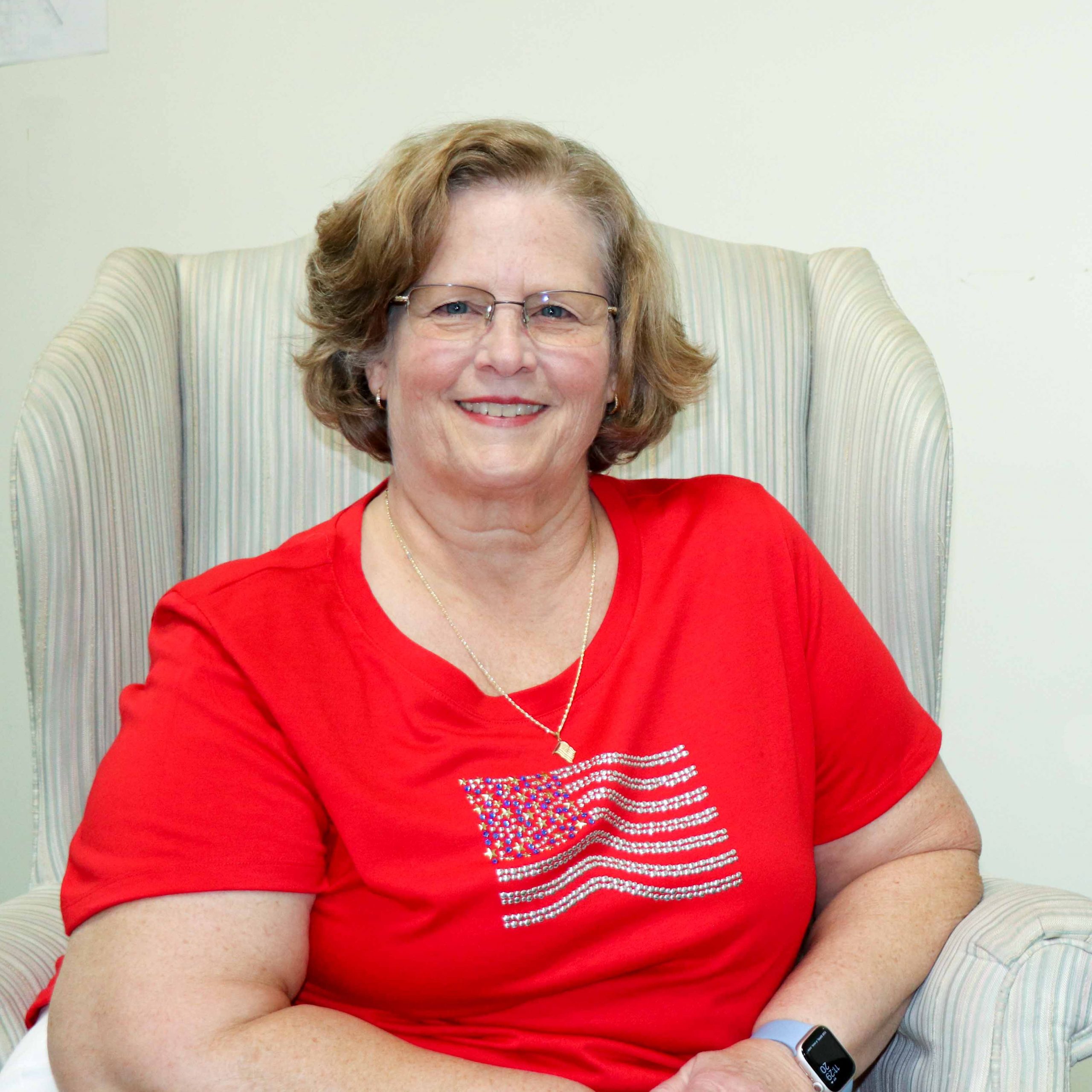 SABQG vice president Kathye DeLuca wearing a red shirt with american flag