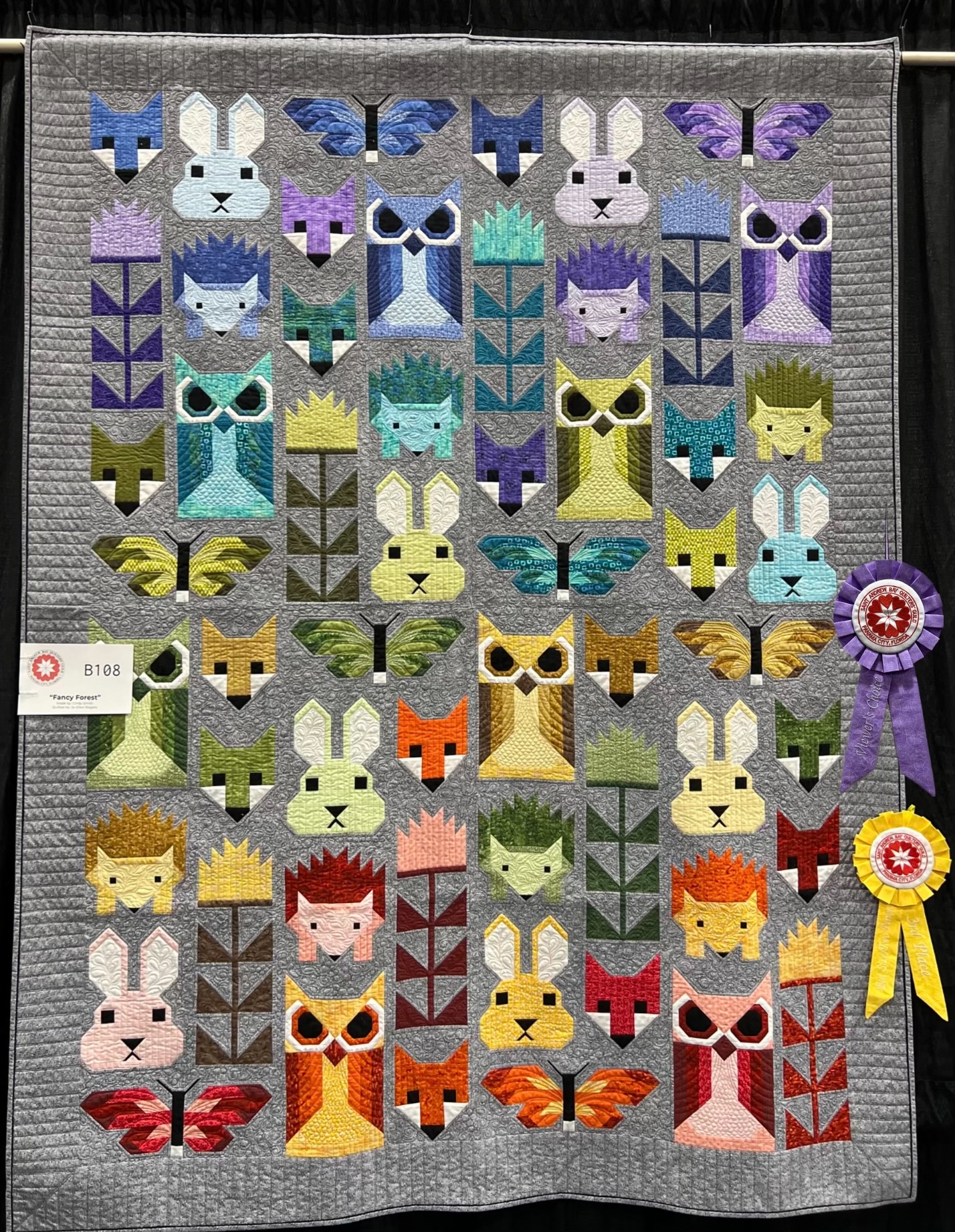 Quilt of cartoon animal squares that won the peoples choice ribbon